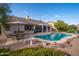 Inviting backyard featuring a pristine pool, desert landscaping, a covered patio, and an outdoor dining set at 835 W Beechnut Dr, Chandler, AZ 85248