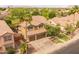 Aerial view of the house showcasing the surrounding neighborhood, landscaping, and two-car garage at 9708 E Pampa Ave, Mesa, AZ 85212