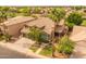 Aerial view of the two-story house highlighting its tile roof, mature landscaping, and convenient two-car garage at 9708 E Pampa Ave, Mesa, AZ 85212