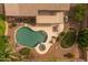 An aerial perspective of the backyard oasis, featuring the pool, patio, and surrounding landscaping at 9708 E Pampa Ave, Mesa, AZ 85212