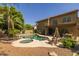 A tranquil backyard offers a sparkling pool and spa, surrounded by a spacious deck and patio seating areas at 9708 E Pampa Ave, Mesa, AZ 85212
