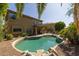 Relaxing backyard showcasing the pristine pool and spa, complemented by a spacious patio and lush landscaping at 9708 E Pampa Ave, Mesa, AZ 85212
