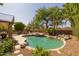 Beautiful pool and hot tub with lush landscaping, dining and seating areas, and privacy wall at 9708 E Pampa Ave, Mesa, AZ 85212