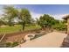 Resort-style backyard with a hot tub, wrought iron fencing and serene golf course views at 9708 E Pampa Ave, Mesa, AZ 85212