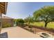 A spacious balcony overlooks the meticulously landscaped backyard and pool area with lush trees and plants at 9708 E Pampa Ave, Mesa, AZ 85212