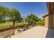 The expansive balcony boasts picturesque views of the lush backyard, mature trees, and pristine landscaping at 9708 E Pampa Ave, Mesa, AZ 85212
