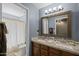 Bathroom with dual sinks, granite countertop, tile backsplash, and shower with curtain at 9708 E Pampa Ave, Mesa, AZ 85212