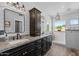 Bathroom with custom cabinets, granite countertop, updated light fixtures, shiplap walls, and walk-in shower at 9708 E Pampa Ave, Mesa, AZ 85212