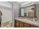 Bathroom featuring double sinks, granite countertops, and a large framed mirror at 9708 E Pampa Ave, Mesa, AZ 85212