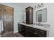 Bathroom with custom cabinets, granite countertop, updated light fixtures and shiplap walls at 9708 E Pampa Ave, Mesa, AZ 85212
