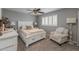Cozy bedroom featuring a ceiling fan, plantation shutters and calming neutral color palette at 9708 E Pampa Ave, Mesa, AZ 85212