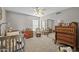 Well-lit Bedroom with a crib, dresser and a rocking chair at 9708 E Pampa Ave, Mesa, AZ 85212