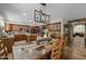Spacious dining area with tile floors, modern lighting, and decorative wood table set for dinner at 9708 E Pampa Ave, Mesa, AZ 85212