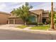 Charming two-story home featuring a three-car garage, manicured lawn, and mature tree, creating a welcoming curb appeal at 9708 E Pampa Ave, Mesa, AZ 85212