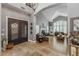 Grand foyer with high ceilings, a large chandelier, decorative doors, tile flooring, and an open floor plan at 9708 E Pampa Ave, Mesa, AZ 85212