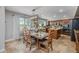 Open-concept dining area with a view into a spacious kitchen featuring granite countertops and stainless steel appliances at 9708 E Pampa Ave, Mesa, AZ 85212