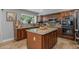 Gourmet kitchen with custom cabinets, granite countertops, stainless steel appliances, and a functional center island at 9708 E Pampa Ave, Mesa, AZ 85212