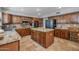 Well-equipped kitchen featuring custom cabinets, granite countertops, a center island, and stainless steel appliances at 9708 E Pampa Ave, Mesa, AZ 85212