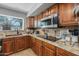 Close-up of kitchen featuring stainless steel appliances, granite countertops, and custom cabinets at 9708 E Pampa Ave, Mesa, AZ 85212