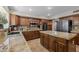 Kitchen featuring a large island, wood cabinets and tile flooring at 9708 E Pampa Ave, Mesa, AZ 85212