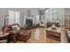 Cozy living room features a fireplace, hardwood floors, and plantation shutters for a warm and inviting atmosphere at 9708 E Pampa Ave, Mesa, AZ 85212