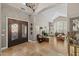 Grand foyer leading to a living room with high ceilings, large windows, and a cozy fireplace at 9708 E Pampa Ave, Mesa, AZ 85212