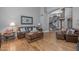 Spacious living room boasting hardwood floors, comfortable seating, and a view of the staircase at 9708 E Pampa Ave, Mesa, AZ 85212