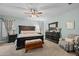 Serene main bedroom with a dark wood furniture set and cozy armchair in the corner at 9708 E Pampa Ave, Mesa, AZ 85212