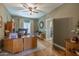 Home office with a large wooden desk, hardwood floors, and natural lighting at 9708 E Pampa Ave, Mesa, AZ 85212