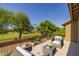Relaxing patio area with cozy chairs, a coffee table, and a serene view of the pool and garden at 9708 E Pampa Ave, Mesa, AZ 85212