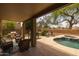 Covered patio with dining area and lounge seating overlooking the pool at 9708 E Pampa Ave, Mesa, AZ 85212