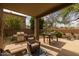 Cozy outdoor patio with stainless steel BBQ, table, and relaxing wicker chairs at 9708 E Pampa Ave, Mesa, AZ 85212