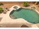An inviting pool features a rock waterfall, integrated spa, and plenty of space for relaxing poolside at 9708 E Pampa Ave, Mesa, AZ 85212