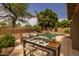 An outdoor dining table set with view of the beautiful pool and landscaping at 9708 E Pampa Ave, Mesa, AZ 85212