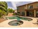 Beautiful backyard pool with spa, rock waterfall, and landscaped surroundings at 9708 E Pampa Ave, Mesa, AZ 85212