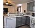 Kitchen featuring gray cabinets, white appliances, and gray and white backsplash at 10951 N 91St Ave # 255, Peoria, AZ 85345