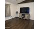 An inviting living room featuring hardwood floors and a large entertainment center at 10951 N 91St Ave # 255, Peoria, AZ 85345