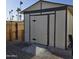 The backyard features a storage shed with a concrete ramp and black accents at 10951 N 91St Ave # 255, Peoria, AZ 85345