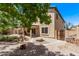 Lovely backyard with a rock pond feature, covered patio, gravel landscaping, and a private gate at 12375 W Meadowbrook Ave, Avondale, AZ 85392