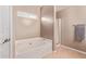 Bathroom with a soaking tub, a separate shower, tile floors, and neutral paint at 12375 W Meadowbrook Ave, Avondale, AZ 85392
