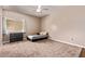 Bright bedroom with carpet, ceiling fan, and neutral color scheme perfect for relaxation at 12375 W Meadowbrook Ave, Avondale, AZ 85392