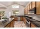 This kitchen features wood cabinetry, stainless steel appliances, a center island, and an abundance of counter space at 12375 W Meadowbrook Ave, Avondale, AZ 85392