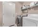 Well-organized laundry room with modern washer and dryer, plus convenient shelving for storage at 12375 W Meadowbrook Ave, Avondale, AZ 85392