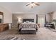 Comfortable primary bedroom featuring a ceiling fan, carpeting, neutral paint, and ample natural light at 12375 W Meadowbrook Ave, Avondale, AZ 85392