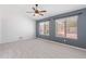 Bedroom featuring a ceiling fan and windows with a pool view at 13630 W Redfield Rd, Surprise, AZ 85379