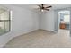 Spacious bedroom featuring tile floors, a ceiling fan, and natural light from a large window at 13630 W Redfield Rd, Surprise, AZ 85379