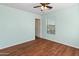 Light-filled bedroom with hardwood floors, a ceiling fan, and a window with bright, natural lighting at 13630 W Redfield Rd, Surprise, AZ 85379