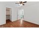 Bedroom featuring a closet and adjoining room, a ceiling fan and hardwood flooring at 13630 W Redfield Rd, Surprise, AZ 85379