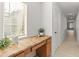 Hallway featuring a built-in desk, natural light from window and access to multiple rooms at 13630 W Redfield Rd, Surprise, AZ 85379