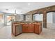 Open kitchen with island and stone archways leading to the living and dining areas at 13630 W Redfield Rd, Surprise, AZ 85379
